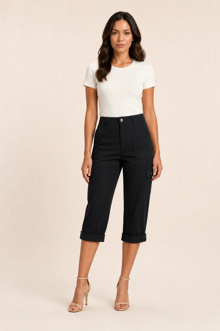 Black cargo capri pants with roll hem on model in contrapposto stance