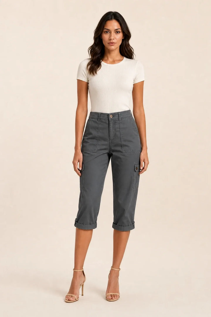 Dark gray cargo capri pants with roll hem on model in contrapposto stance