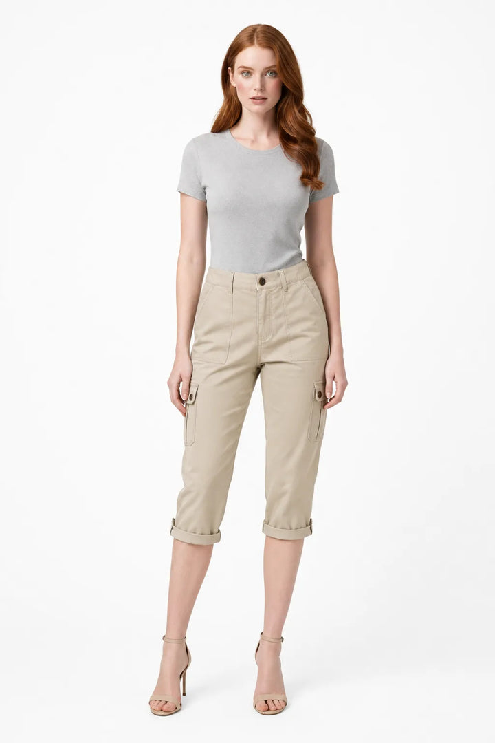 Khaki cargo roll hem capri pants on model in contrapposto stance