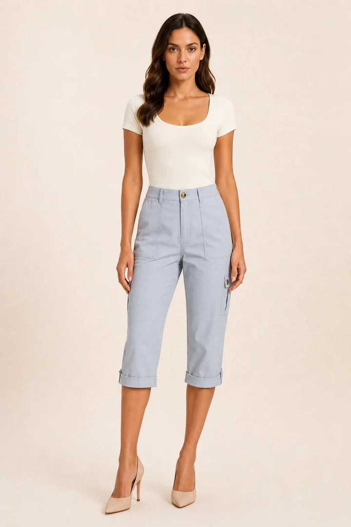 Light blue cargo capri pants with roll hem on model in contrapposto stance