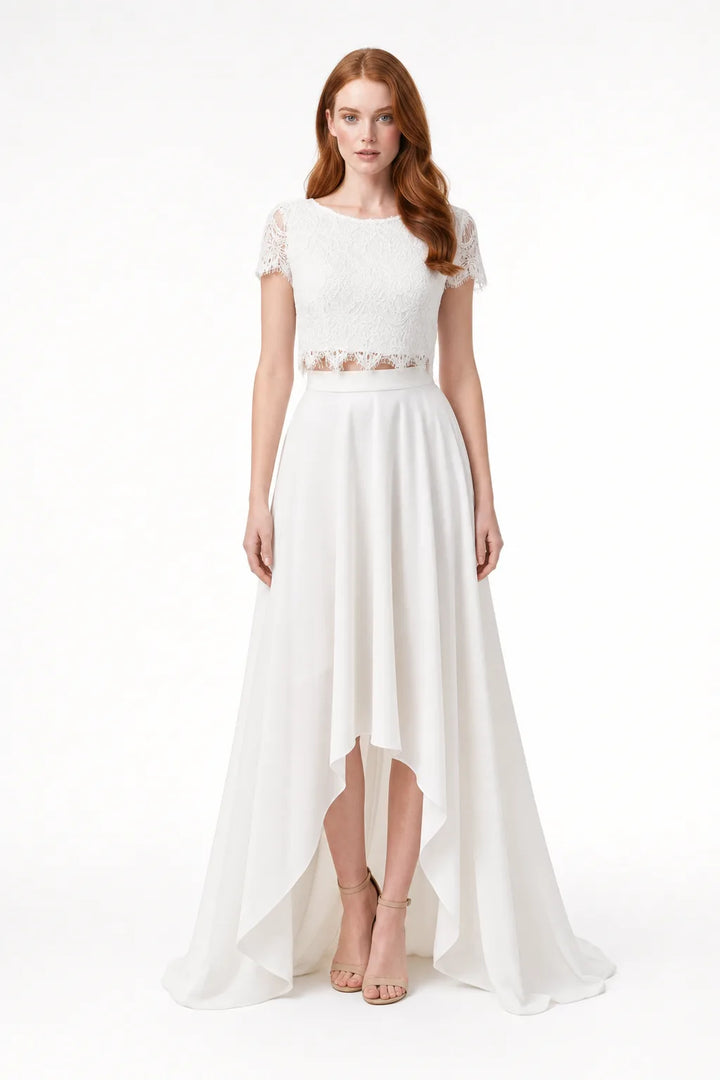 White lace crop bridal top and skirt set on model in contrapposto stance