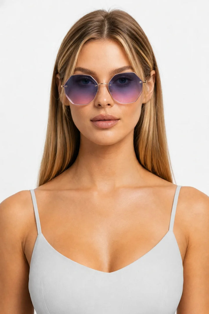 Model wearing oversized octagonal rimless sunglasses in blue-pink, front-facing close-up