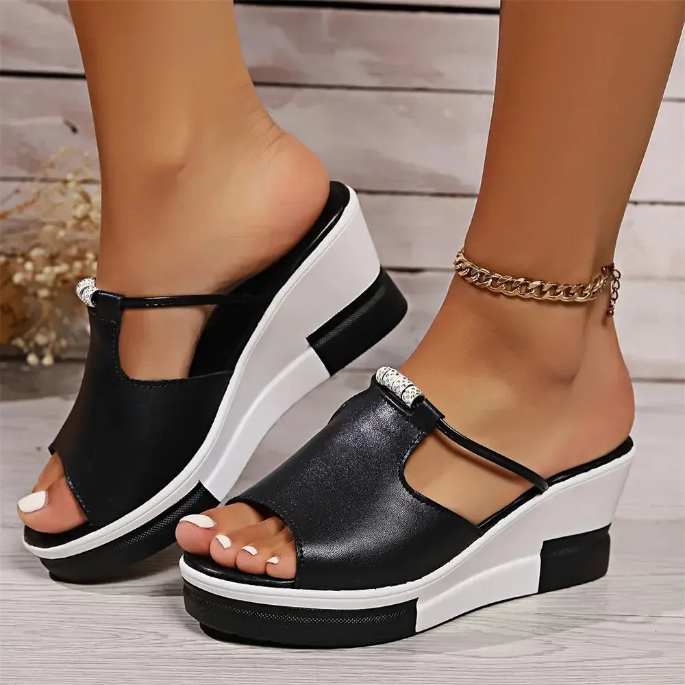 Black platform wedge mule shown from the front