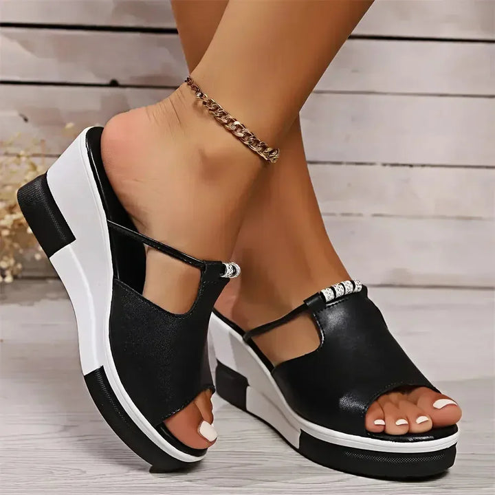 Black platform wedge mule shown from the side profile