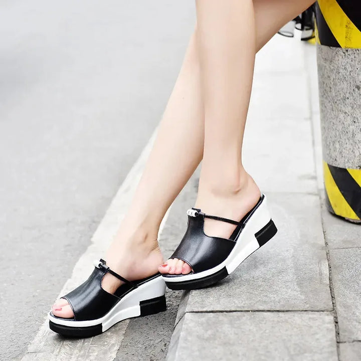 Black platform wedge mule shown from a three-quarter angle