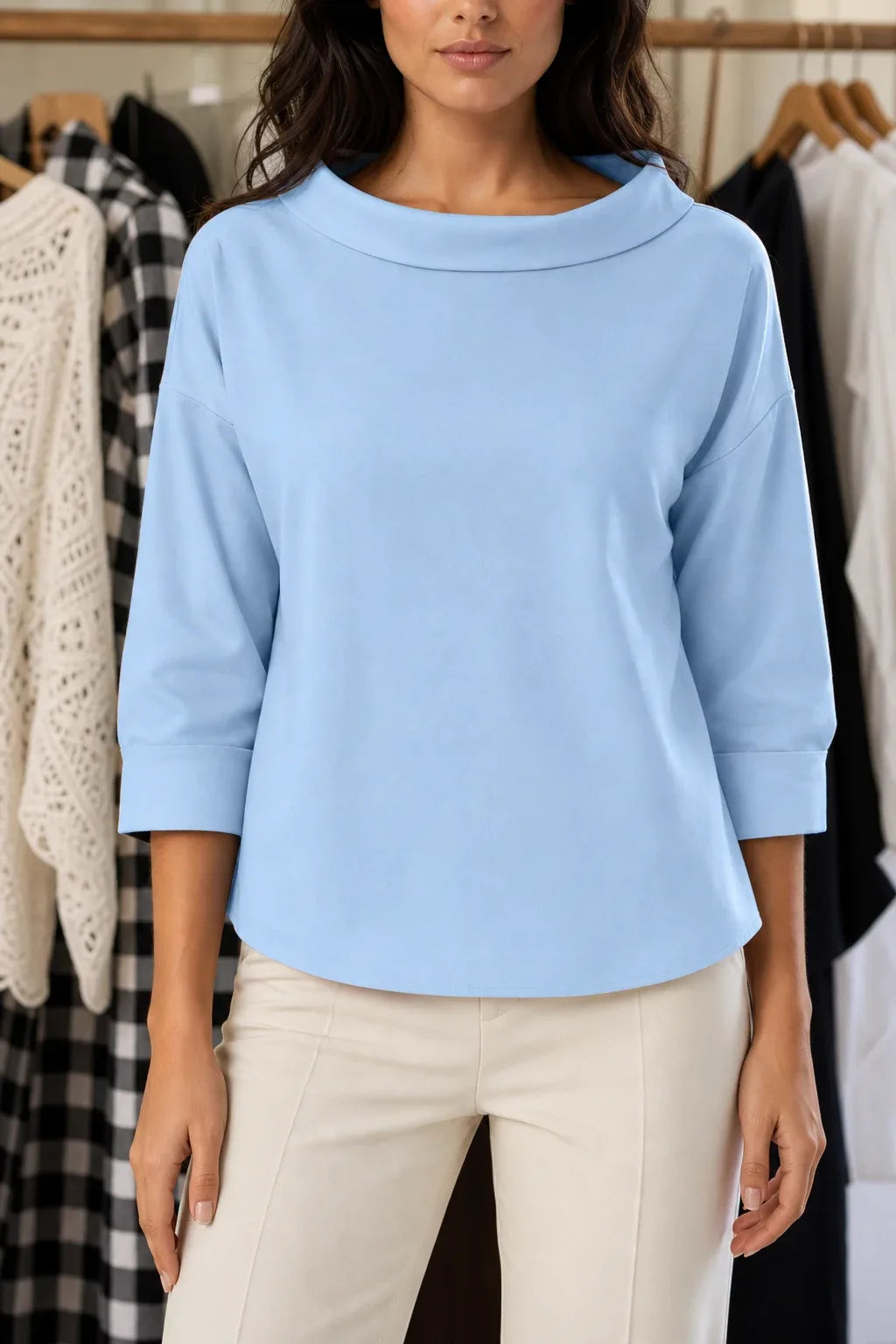 Blue boat neck relaxed top on model in contrapposto stance