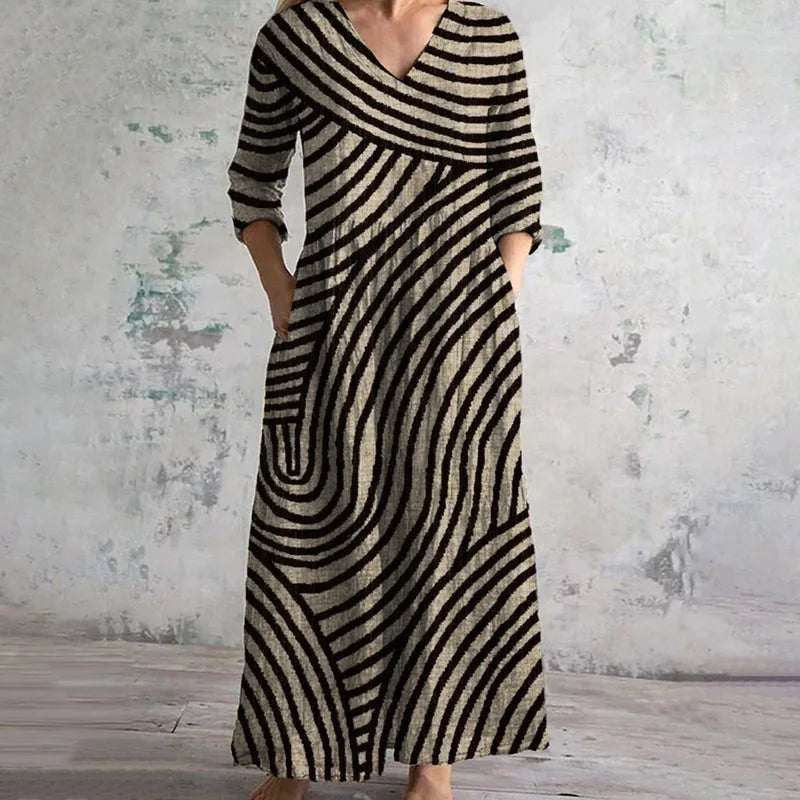 Brown wavy striped maxi dress on standing model, front view