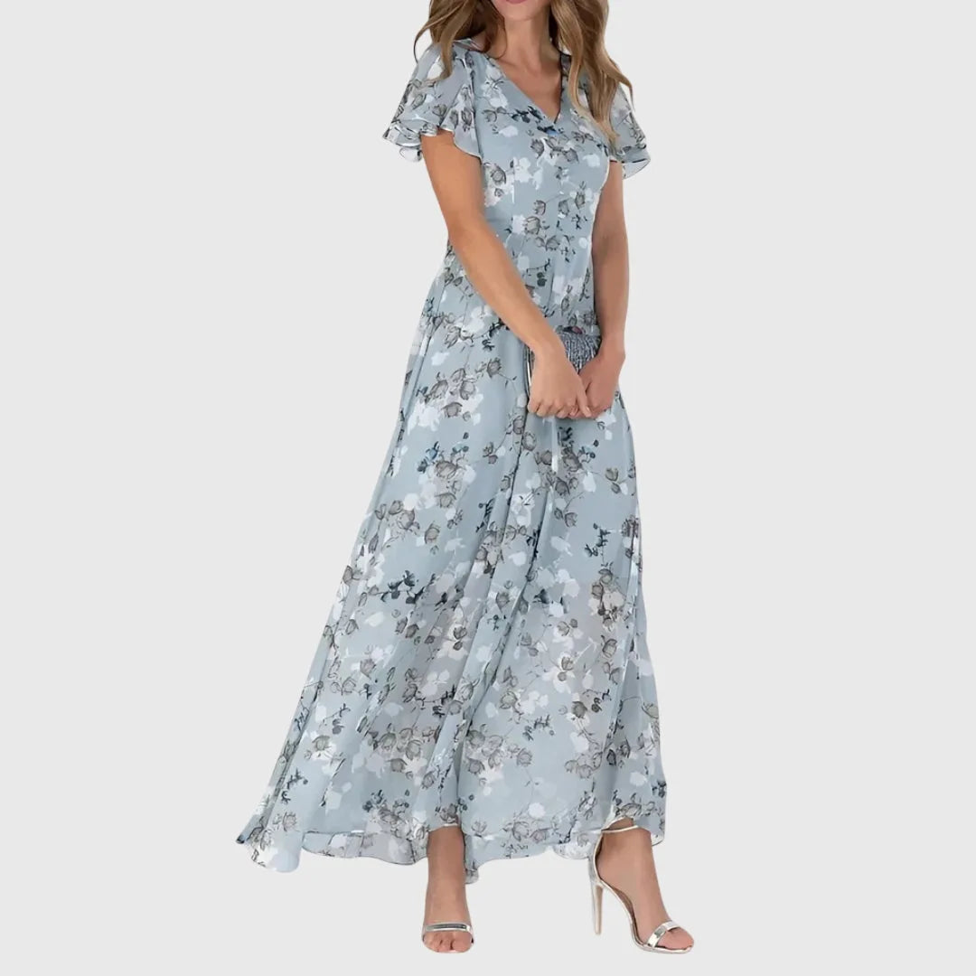 Blue floral chiffon maxi dress on model in three-quarter turn