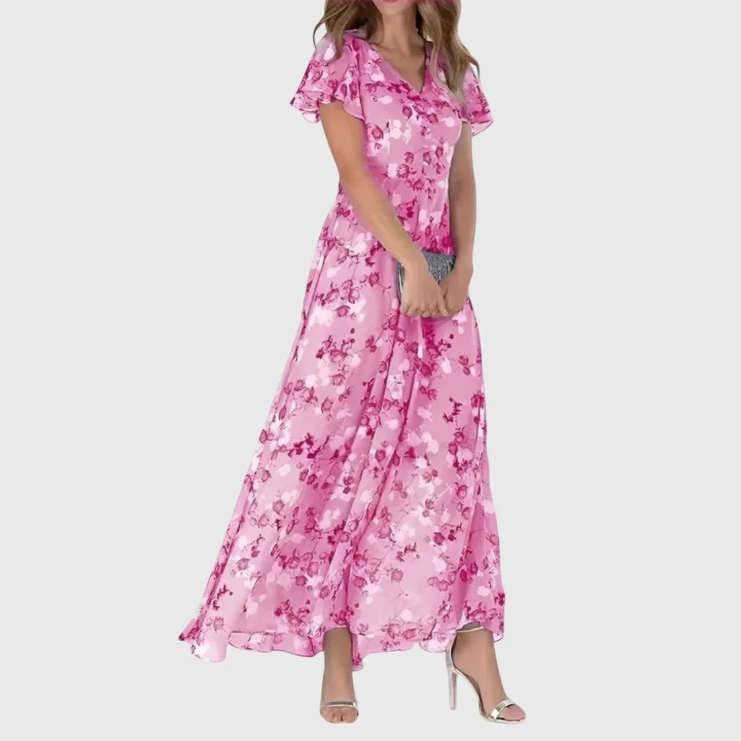 Close-up detail of light pink floral chiffon maxi dress fabric and silhouette