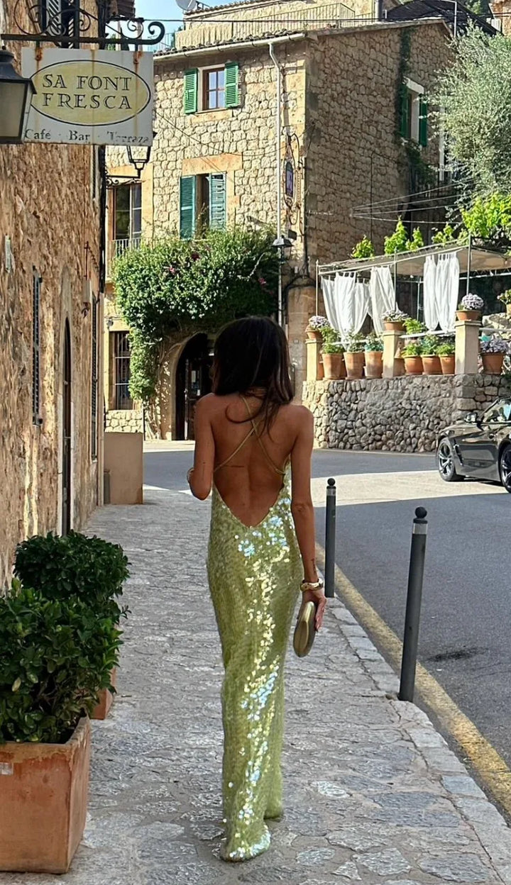 Close-up detail of green sequin fabric on a backless evening gown