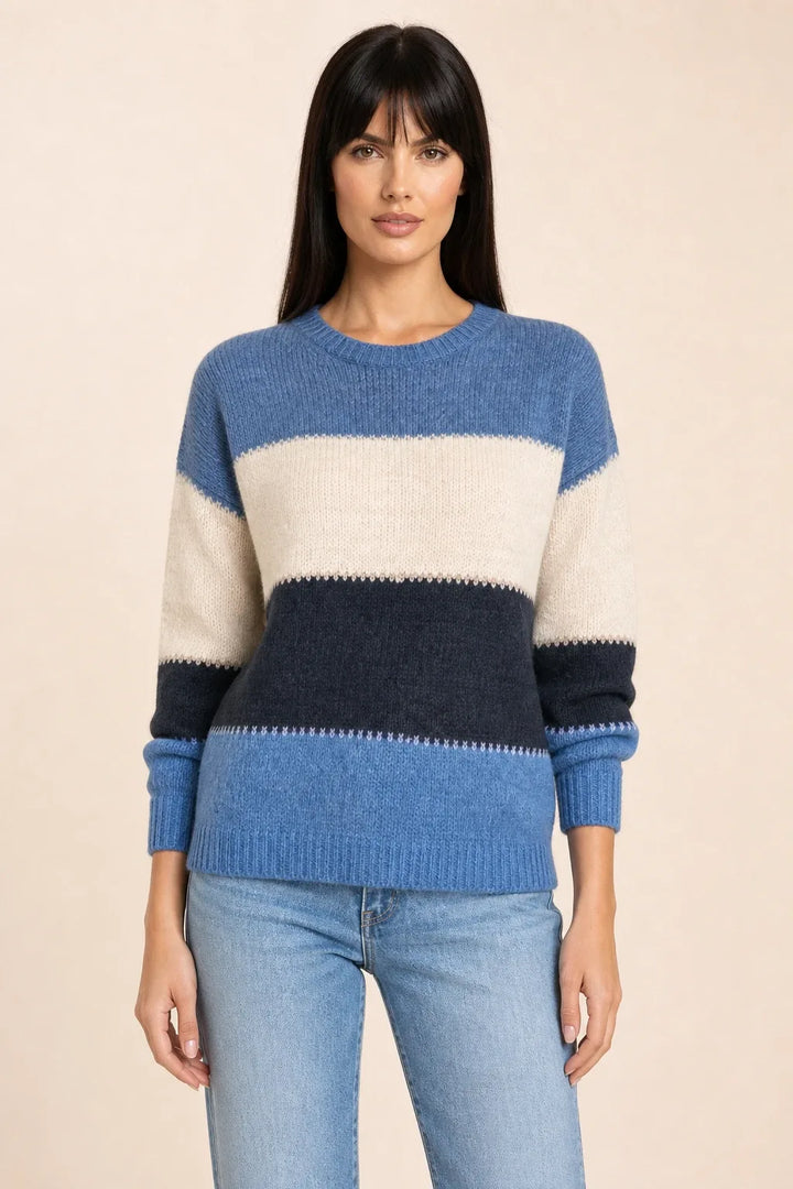 Blue colorblock stripe knit top on model in contrapposto stance