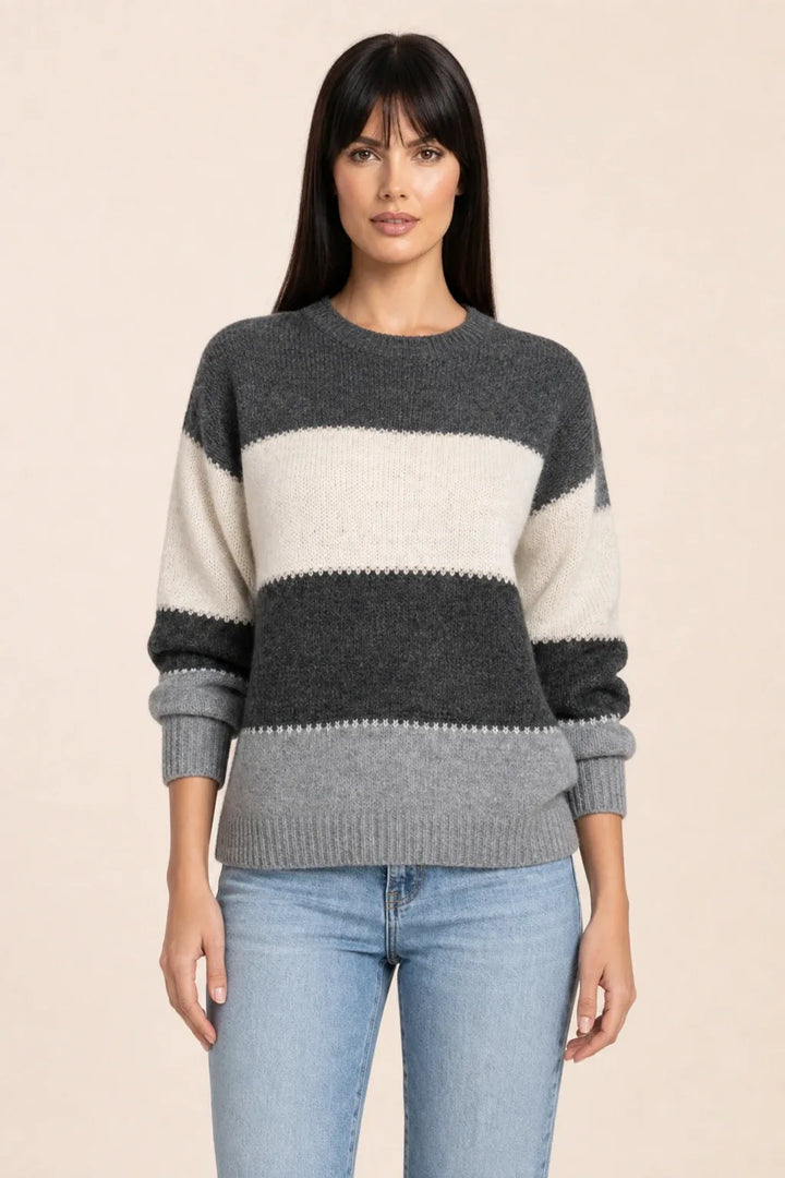 Grey colorblock stripe knit top on model in contrapposto stance
