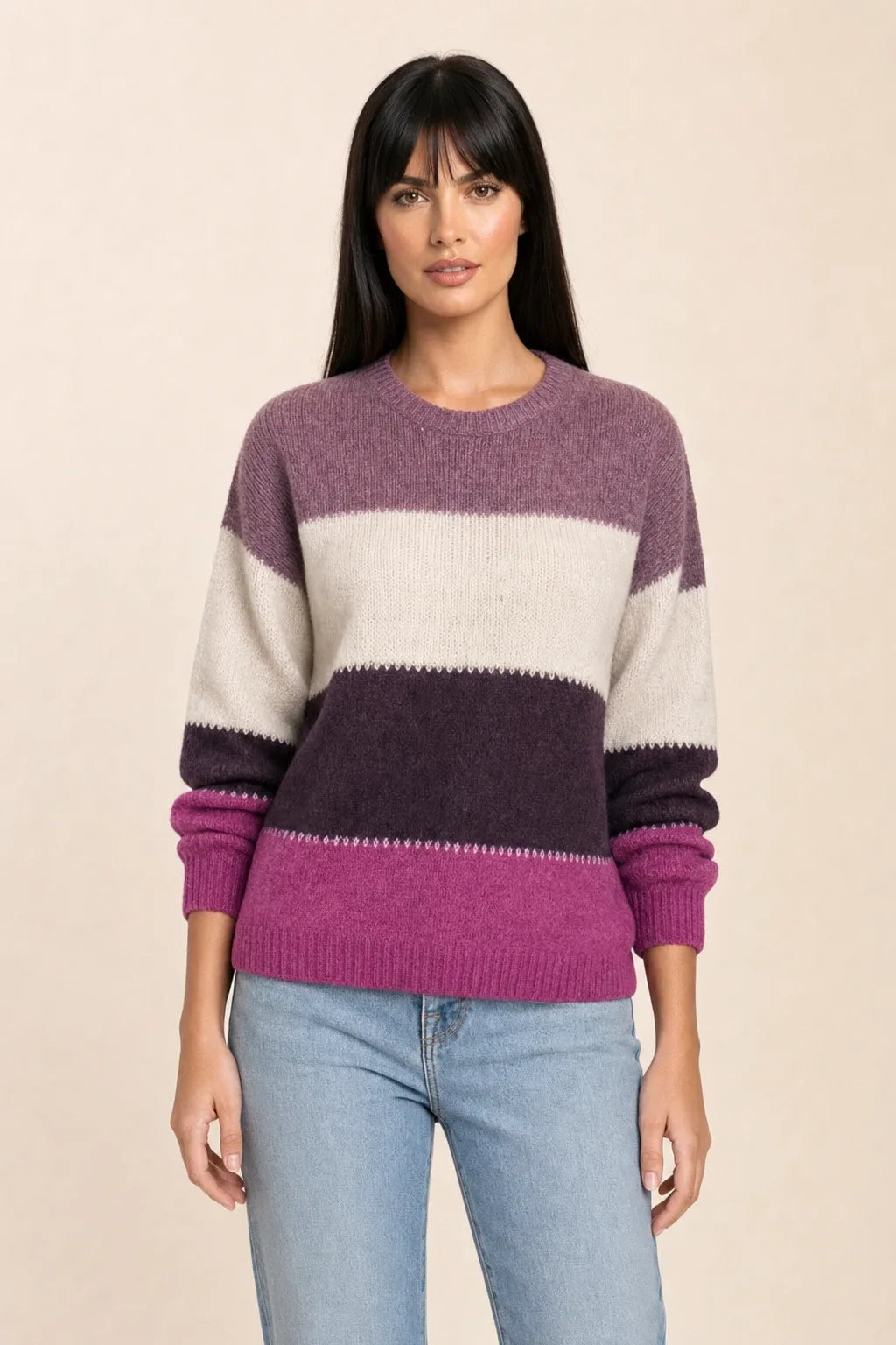 Purple colorblock stripe knit top on model in contrapposto stance