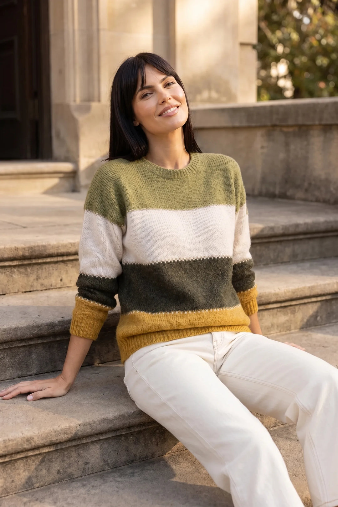 Model wearing yellow colorblock stripe knit top in outdoor lifestyle setting
