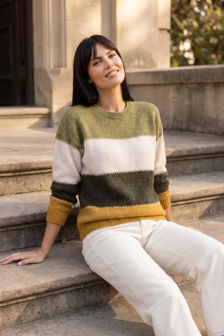 Model wearing yellow colorblock stripe knit top in outdoor lifestyle setting