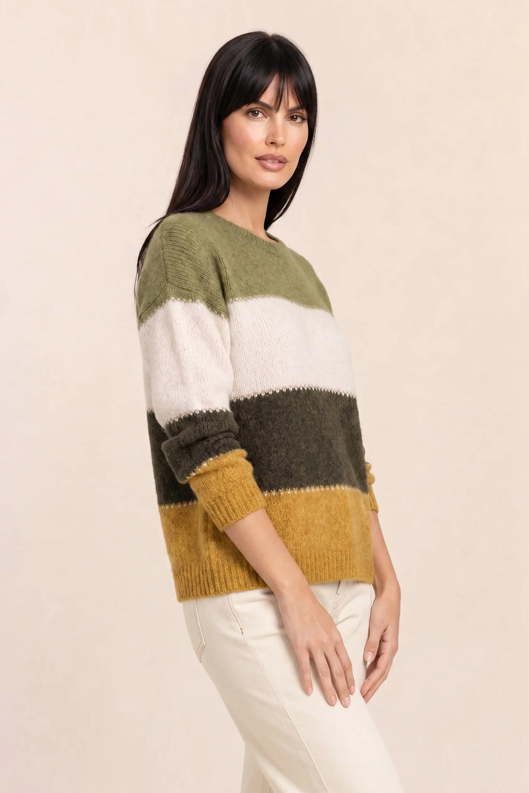 Yellow colorblock stripe knit top on model in three-quarter turn