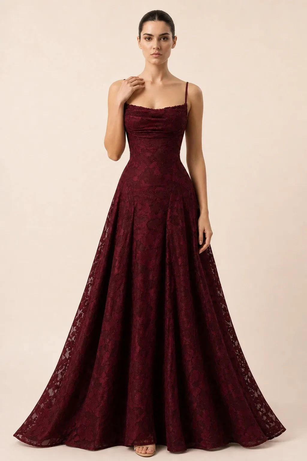 Burgundy lace appliqué gown on model in contrapposto stance