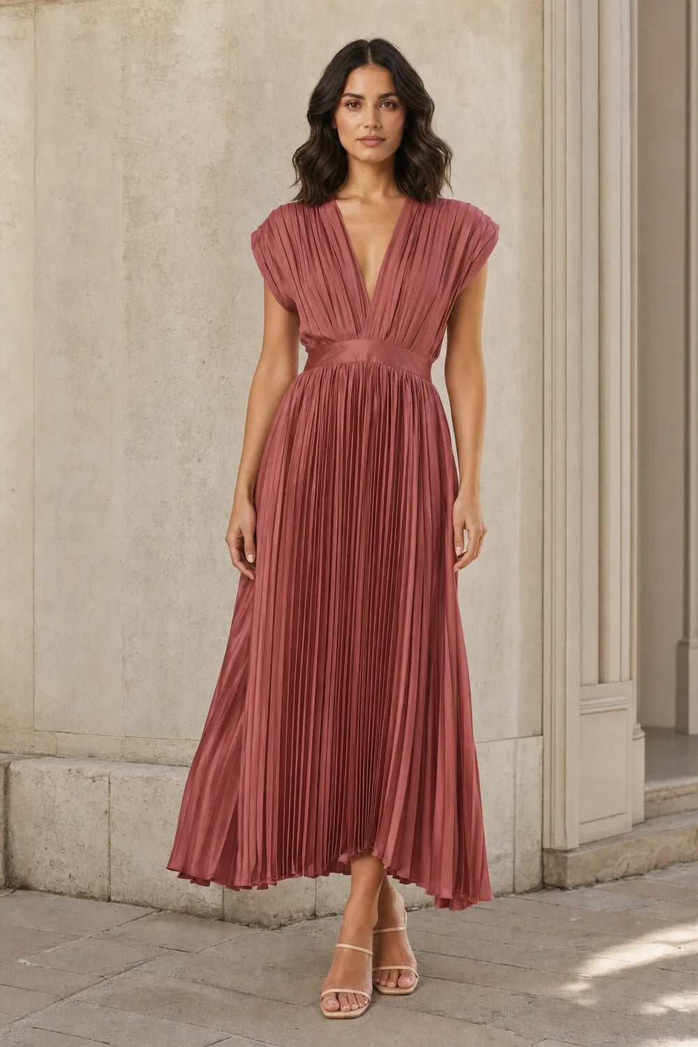 Antique pink pleated midi dress on a model in a contrapposto stance