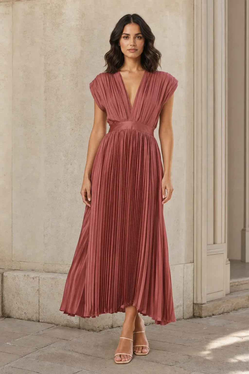 Antique pink pleated midi dress on a model in a contrapposto stance