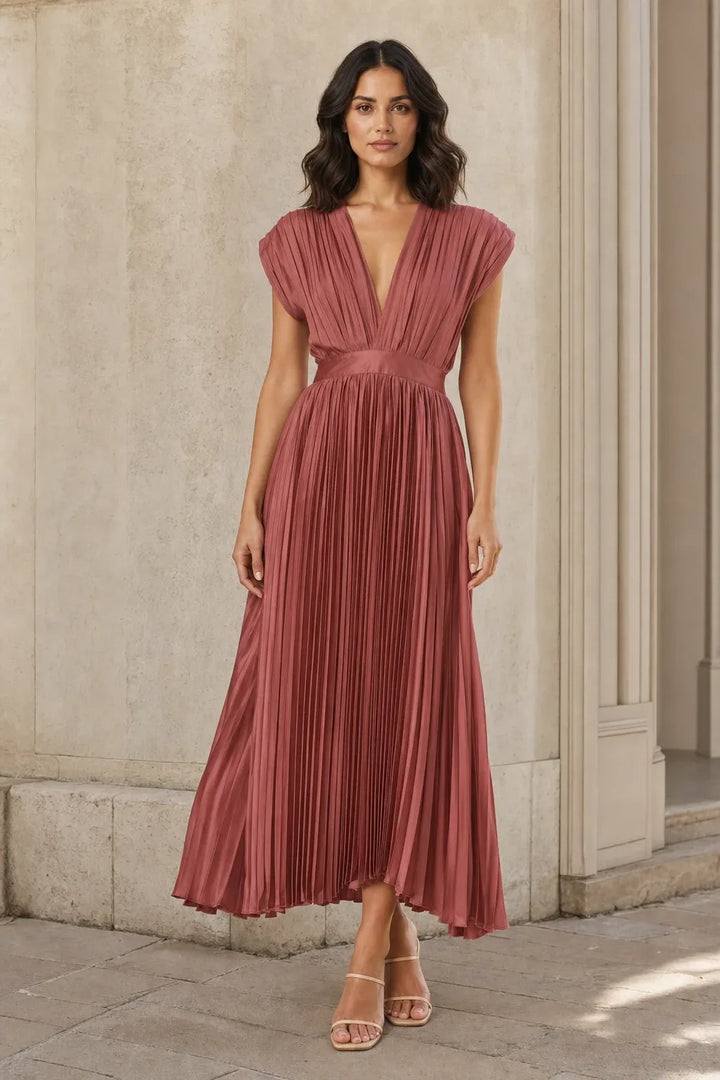 Antique pink pleated midi dress on a model in a contrapposto stance