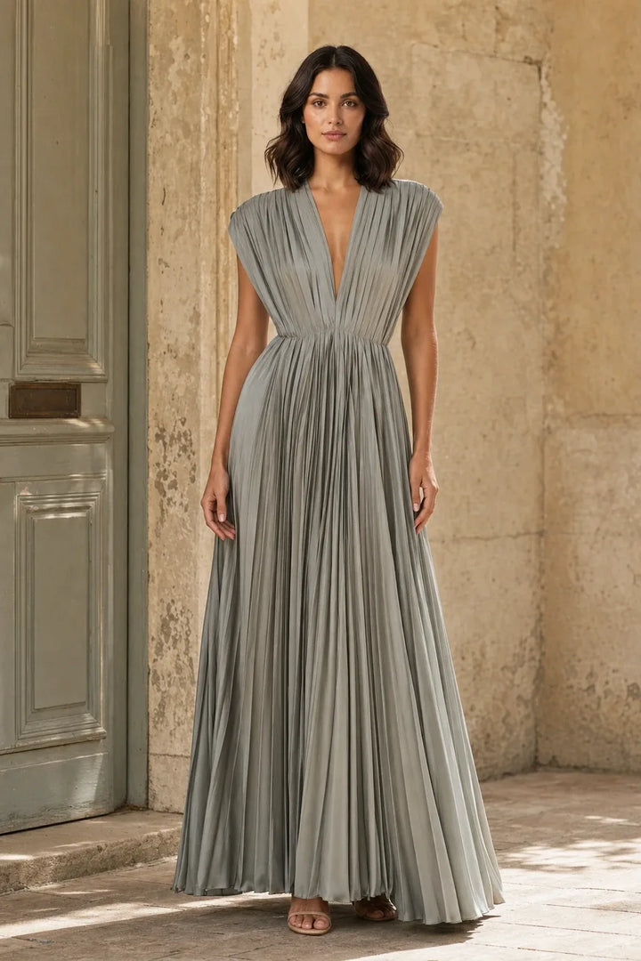 Grey pleated midi dress on a model in a contrapposto stance