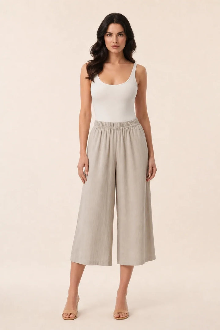 Khaki smocked culotte on model in contrapposto stance, elasticated waistband and wide cropped legs