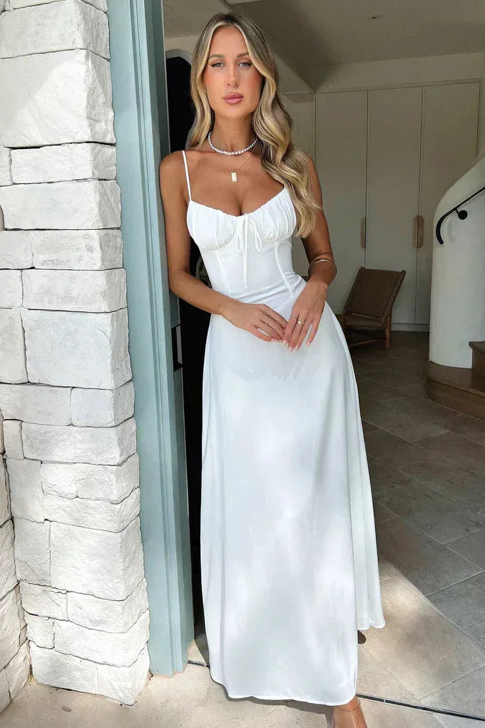 Woman in a white corset mermaid maxi dress, standing in a full-length pose