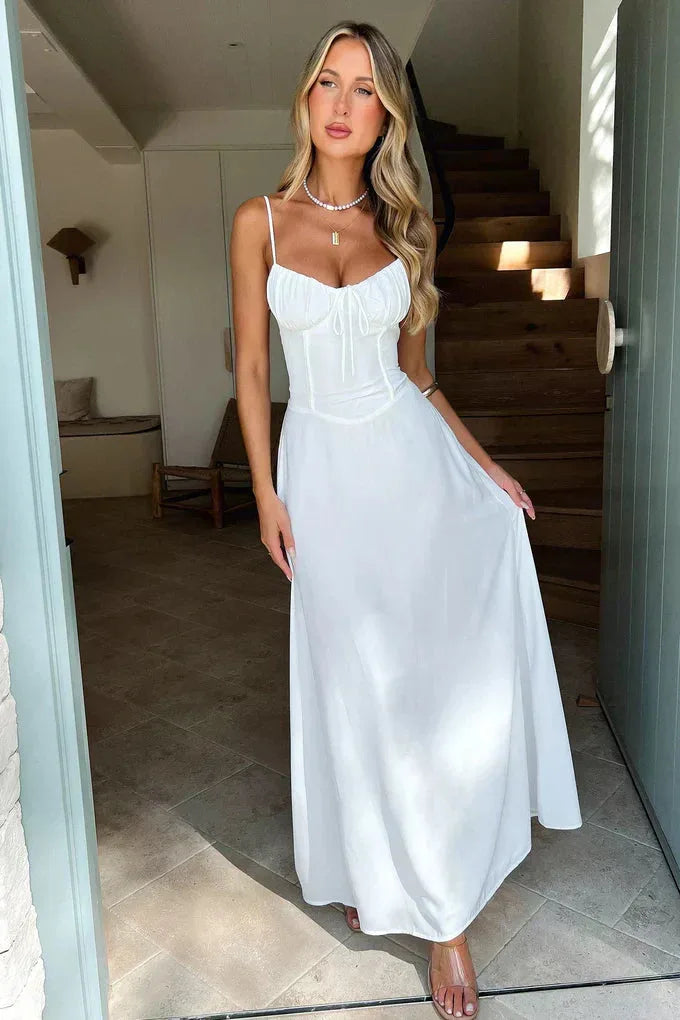 Woman wearing a yellow corset mermaid maxi dress, showcasing the fitted bodice and flared hem