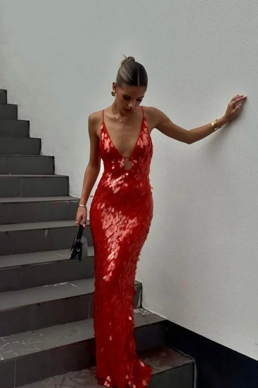 Woman in a red sequin backless gown facing forward, full-length view