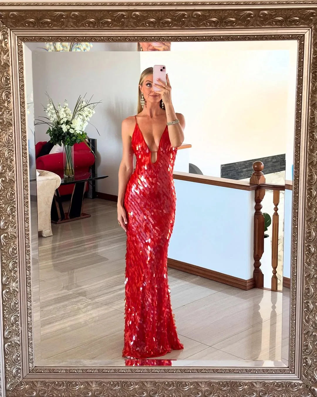 Woman in a red sequin backless gown, additional full-length styling view