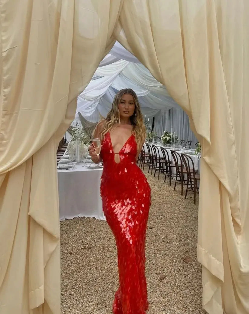 Woman in a red sequin backless gown, further full-length styling view