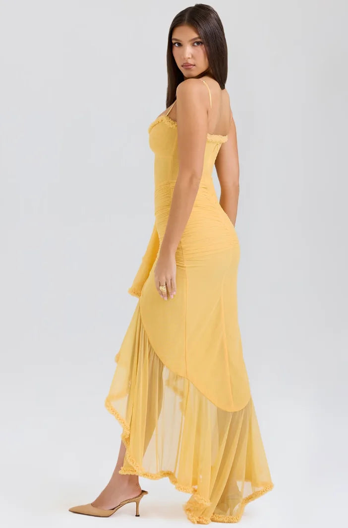 Model in yellow ruffle slit maxi dress, relaxed standing pose