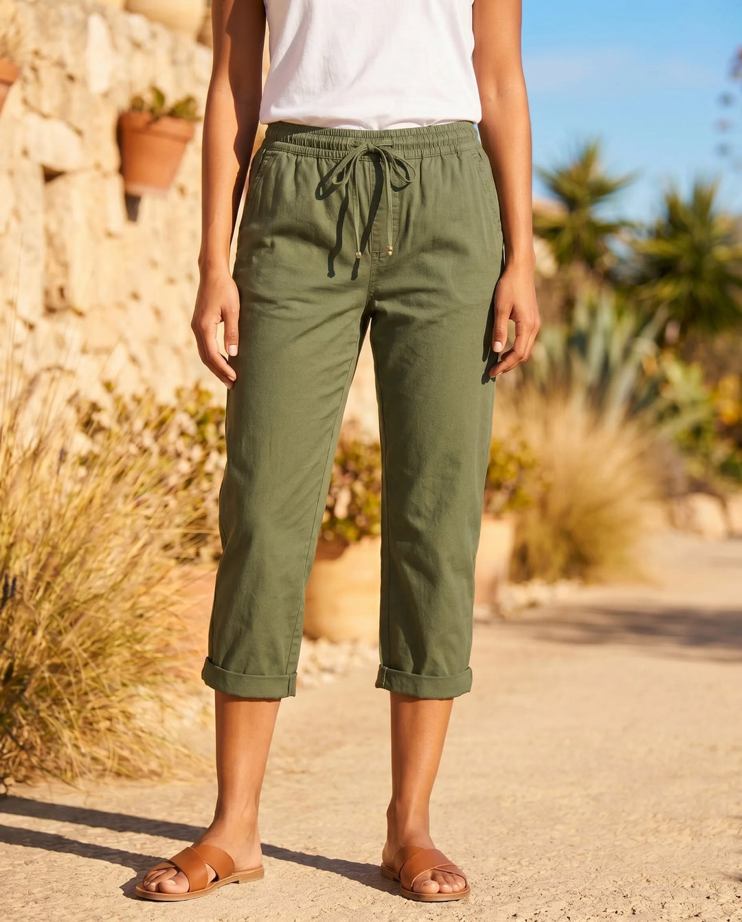 Army green drawstring capri pants on model, relaxed silhouette with tied waist detail