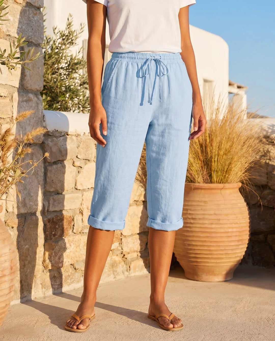 Sky blue drawstring capri pants on model, showcasing soft color and relaxed cropped fit