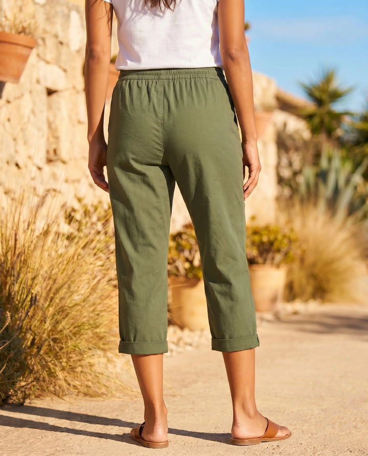White drawstring capri pants on model, front view showing lightweight fabric and easy fit