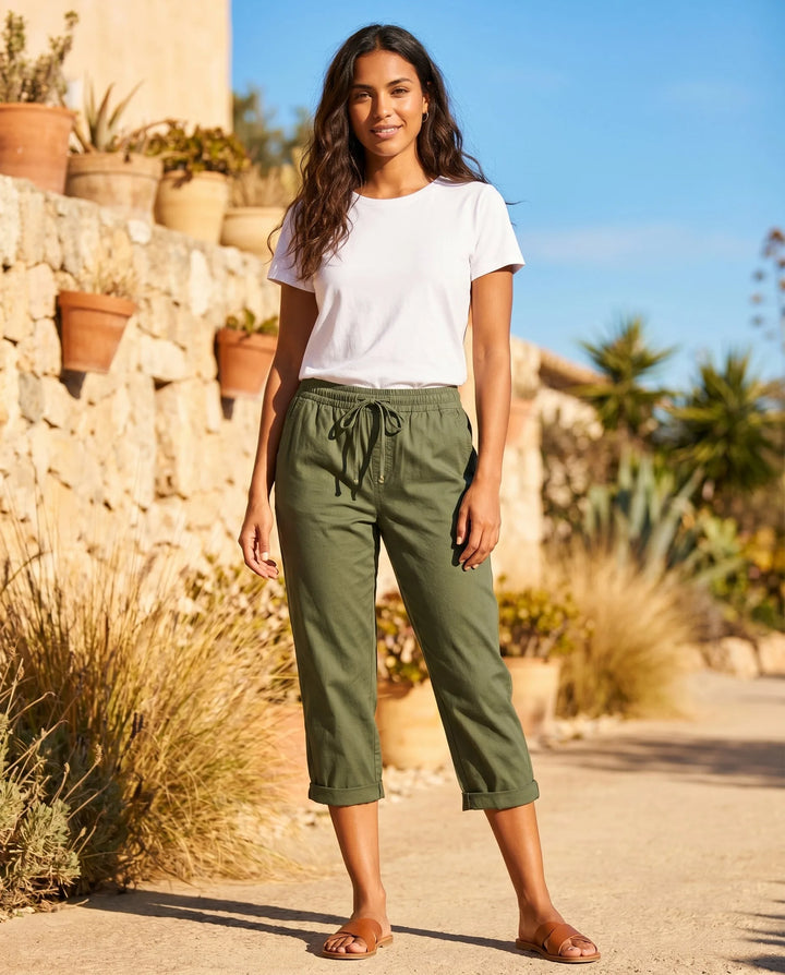 White drawstring capri pants on model, styled view with casual relaxed stance