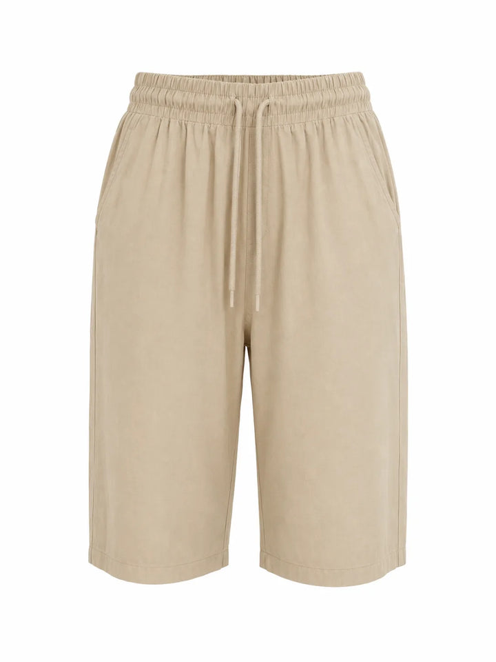 White drawstring capri pants on model, full-length view highlighting drawstring waist detail