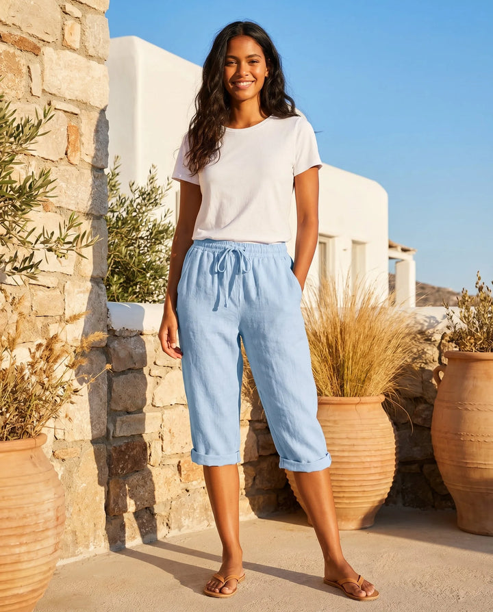 White drawstring capri pants on model, rear or angled view showing overall silhouette