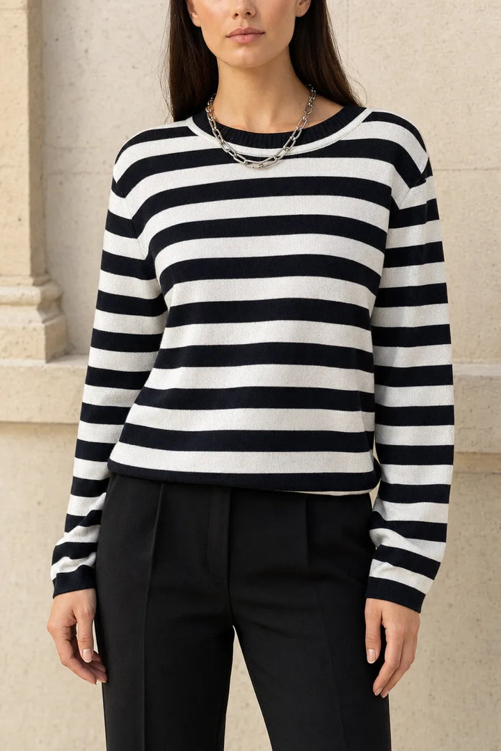 Black striped long sleeve top on model in contrapposto stance