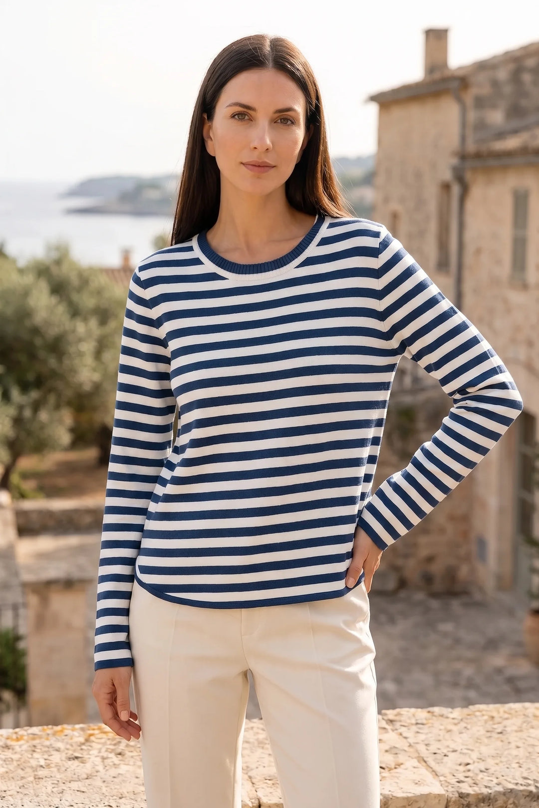 Model wearing blue striped long sleeve top in lifestyle setting