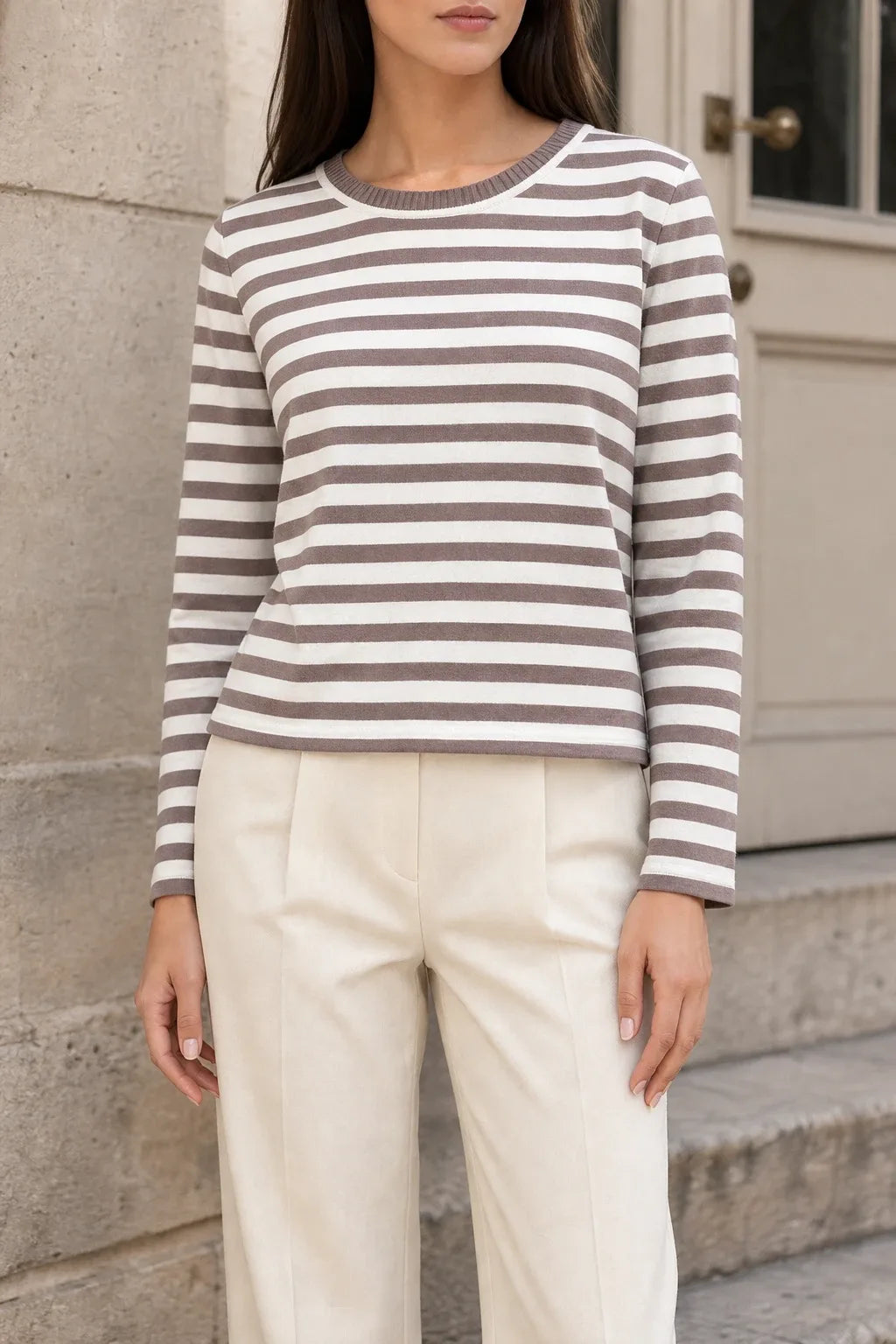 Brown striped long sleeve top on model in contrapposto stance