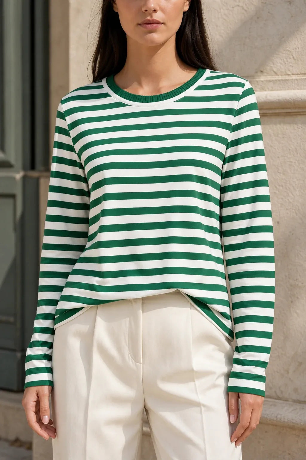 Green striped long sleeve top on model in contrapposto stance