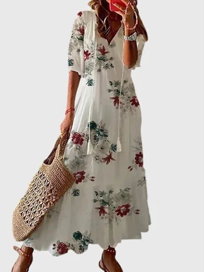 Floral bloom print midi dress on model, featuring a short-sleeve relaxed silhouette in vibrant tones