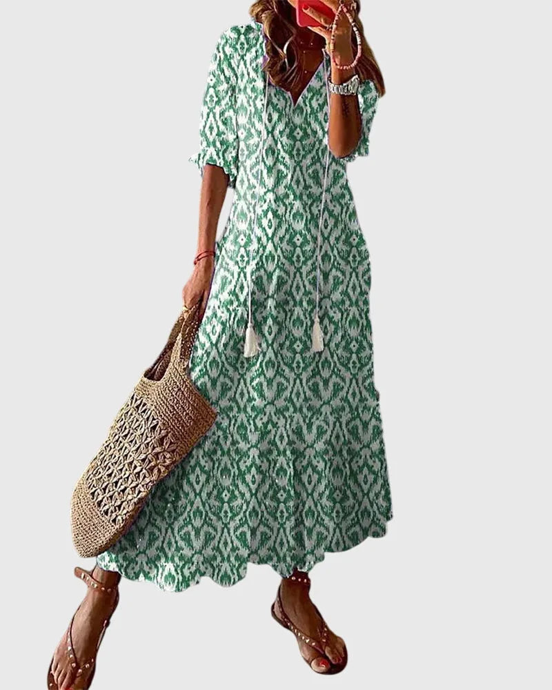 Green ikat print midi dress on model in three-quarter turn, showing relaxed fit and short sleeves
