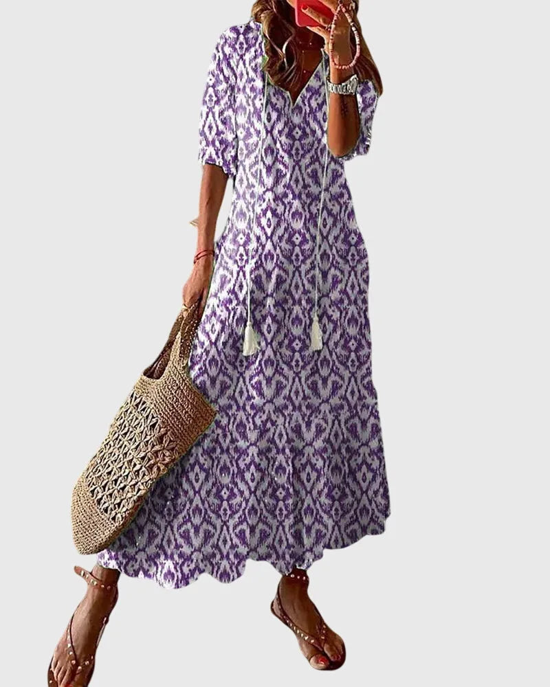 Purple ikat print midi dress on model in side profile, highlighting the silhouette and hem length