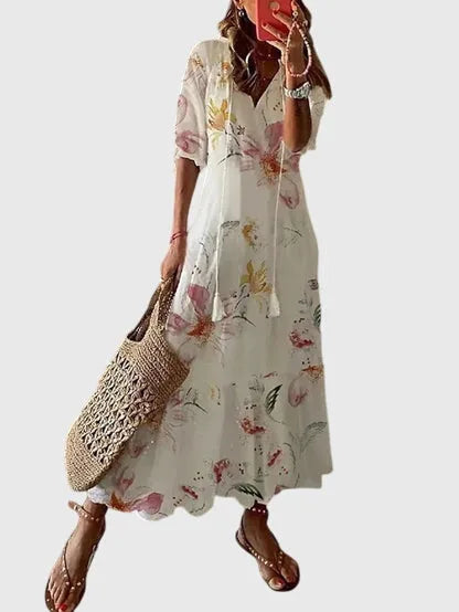 White ikat print midi dress on model, offering a clean bright look with short sleeves and midi hem