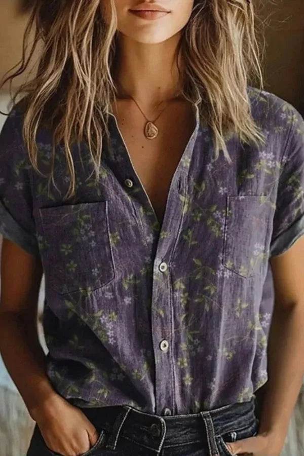 Woman wearing a floral button-front blouse, shown from a three-quarter angle