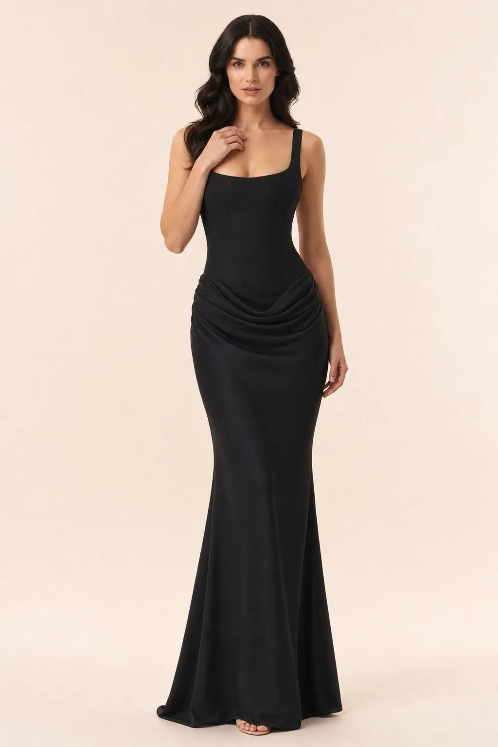 Black corset draped gown on a model in a contrapposto stance