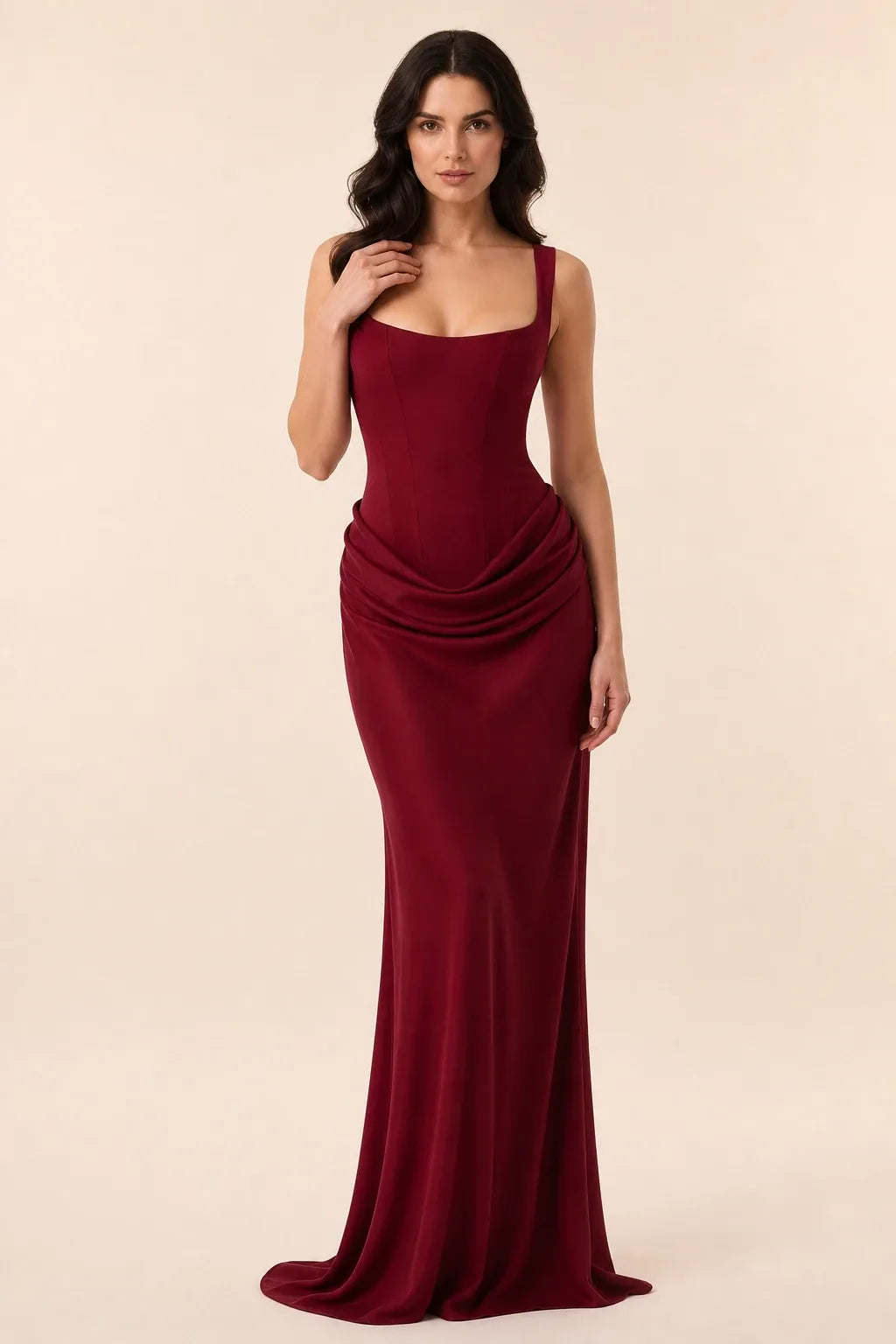 Burgundy corset draped gown on a model in a contrapposto stance