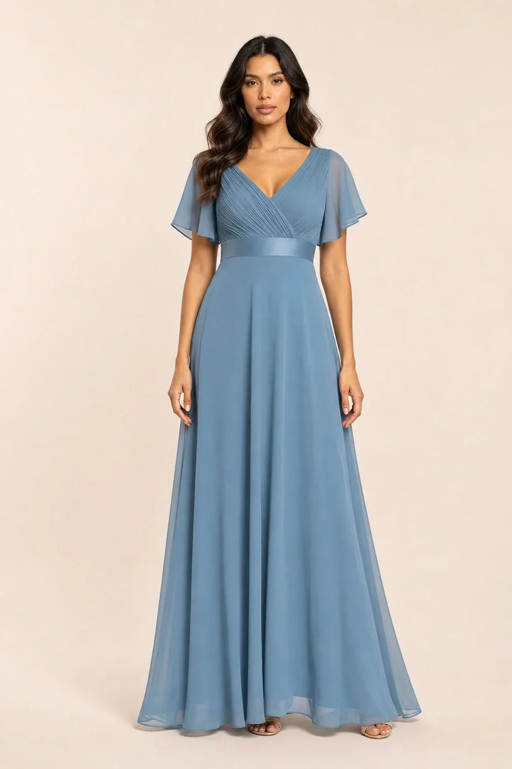 Black and blue flutter sleeve maxi dress on model in contrapposto stance